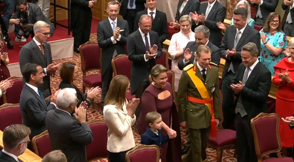 Grand Duchess Maria Teresa of Luxembourg walks into the Chamber of Deputies wearing a burgundy dress