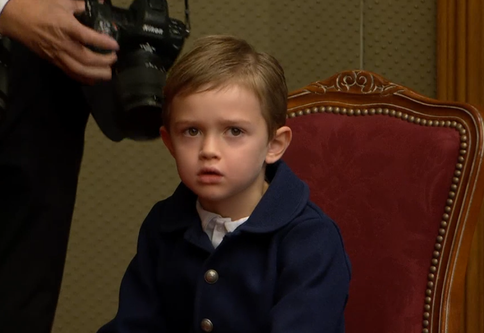 Prince Charles of Luxembourg stays in his seat as the country's parliament rises for his father, Grand Duke Guillaume