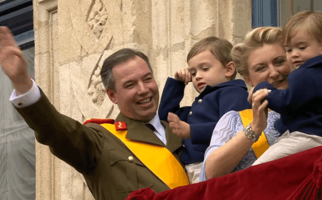 Grand Duke Guillaume of Luxembourg smiles at his family as they wave from the balcony