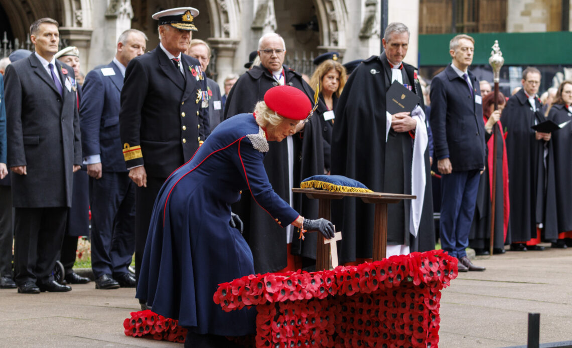 Queen Camilla, in a military inspired outfit, plants a cross at the Field of Remembrance