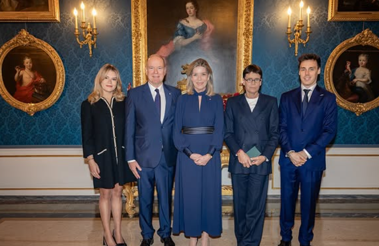 Princess Caroline of Monaco wears a navy blue dress as she stands in the Blue Room of the Prince's Palace in Monaco