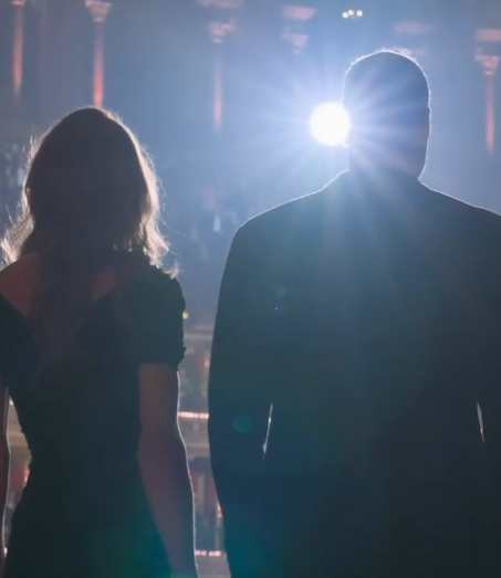 The Prince and Princess of Wales are seen from the back with a bright light placing them in silhouette