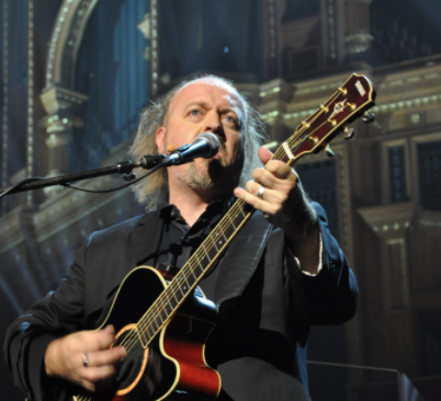 Close up of Bill Bailey playing a guitar