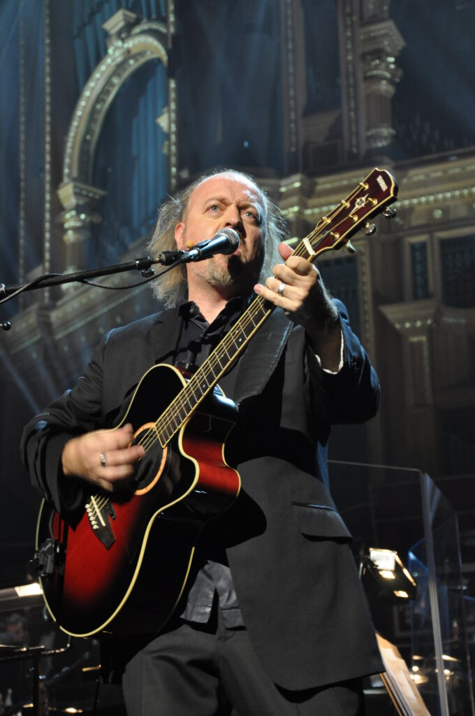 Bill Bailey plays the guitar at the Royal Albert Hall