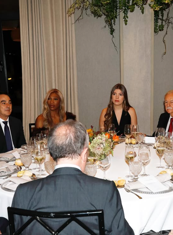 Infant Sofia of Spain sits at a round table next to Serena Williams