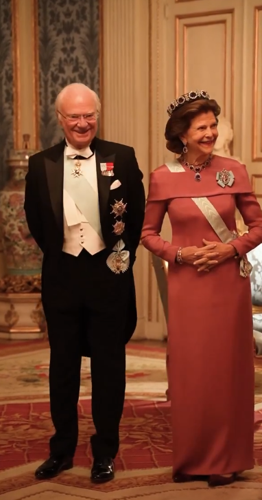 Queen Silvia of Sweden wears a dusky pink dress and purple amethysts