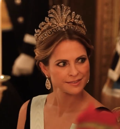 A close up of Princess Madeleine who wears a tiara made of steel