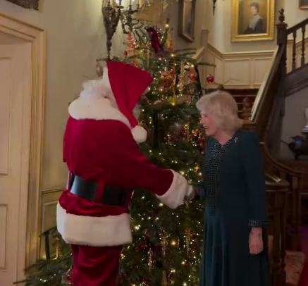 Queen Camilla welcomes Santa to Clarence House in front of a giant Christmas tree