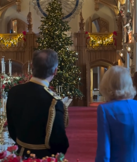 Queen Camilla looks towards a giant Christmas tree
