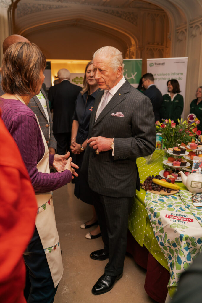 King Charles stands and talks to a group of people
