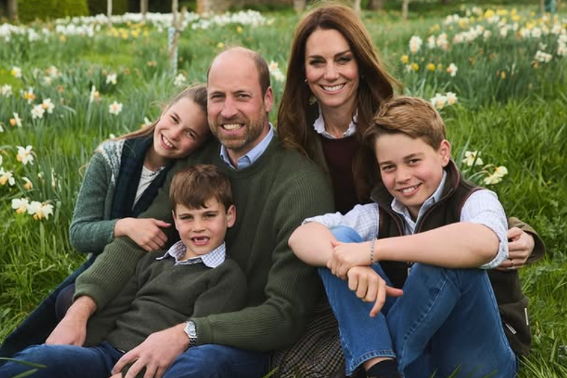 Prince William, Kate and their children sit in a field of daffodils for their Christmas card portrait