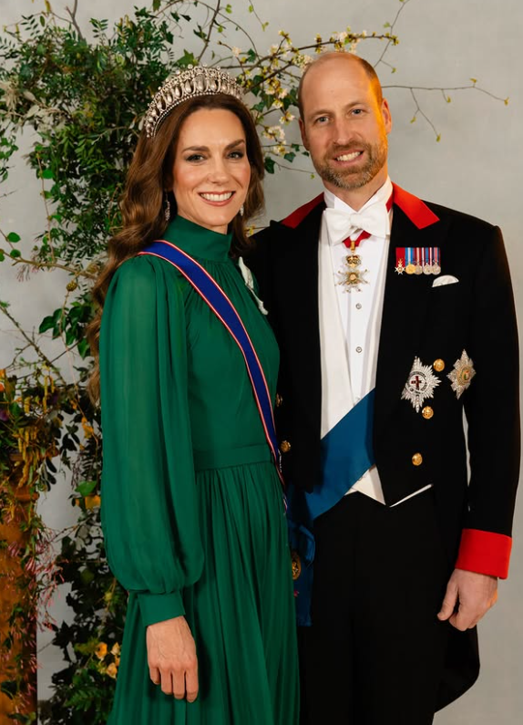 The Prince and Princess of Wales stand in front of a plant for a formal portrait