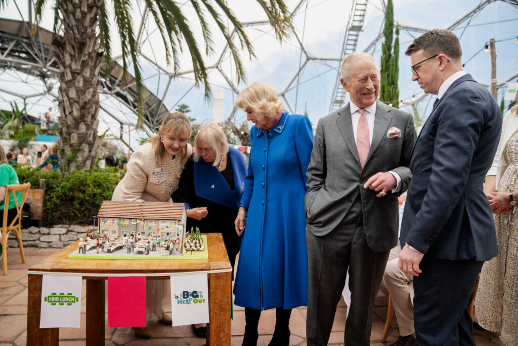 Queen Camilla looks at a cake 
