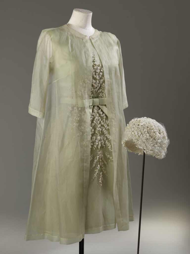 A pale cream dress and hat worn by Queen Elizabeth II