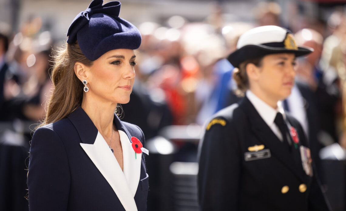 The Princess of Wales wears a navy coat with white lapels and a red poppy