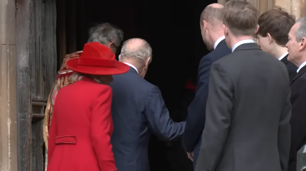 King Charles pats Prince Louis as they walk into St. George's Chapel