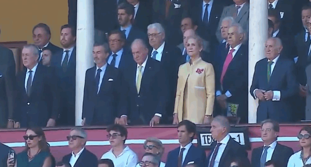 King Juan Carlos of Spain stands for the country's national anthem
