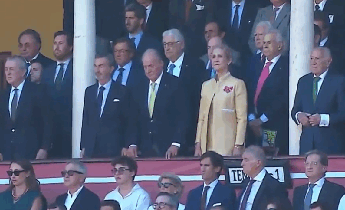 King Juan Carlos of Spain stands for the country's national anthem