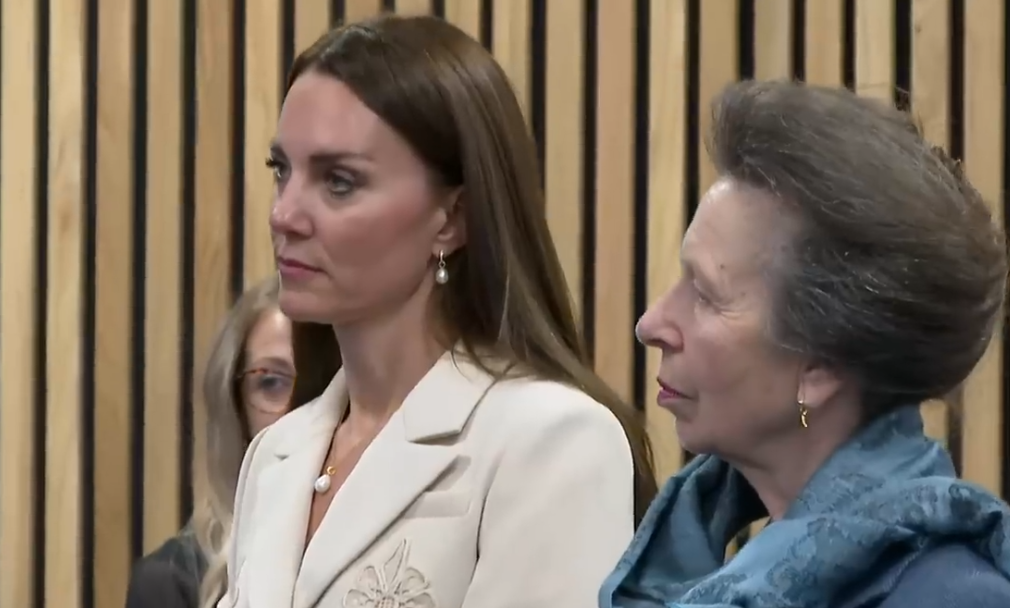 The Princess of Wales and the Princess Royal listen to a midwife