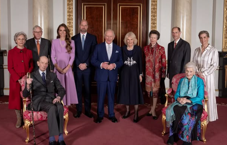 The Royal Family stand in a room n Buckingham Palace for an official portrait