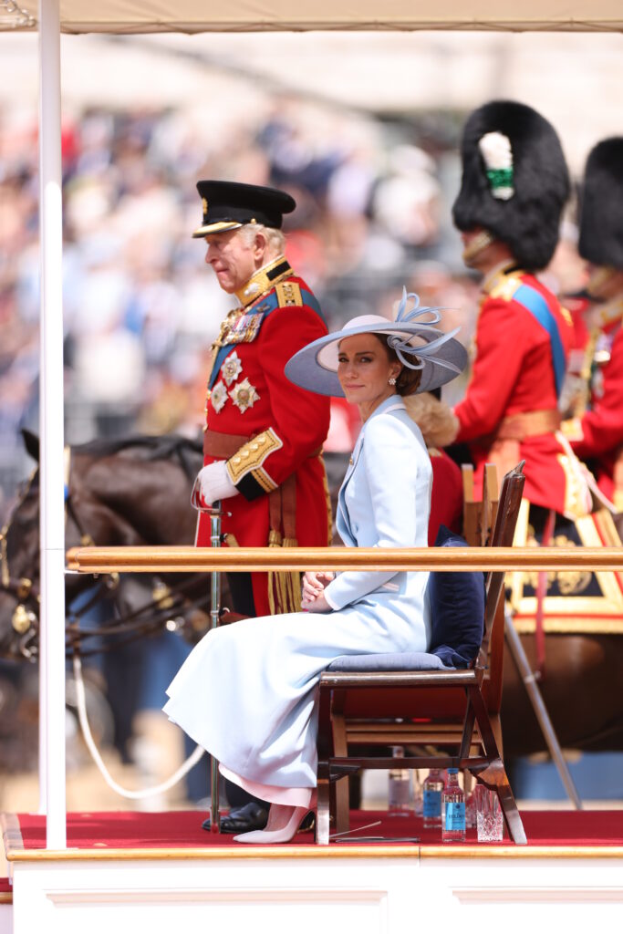 King Charles III stands to take a salute at Trooping the Colour