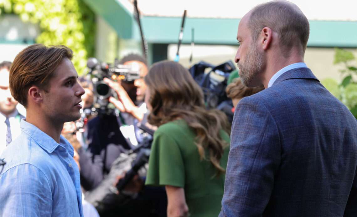Prince William, in a blue jacket, speaks to Arthur Fery