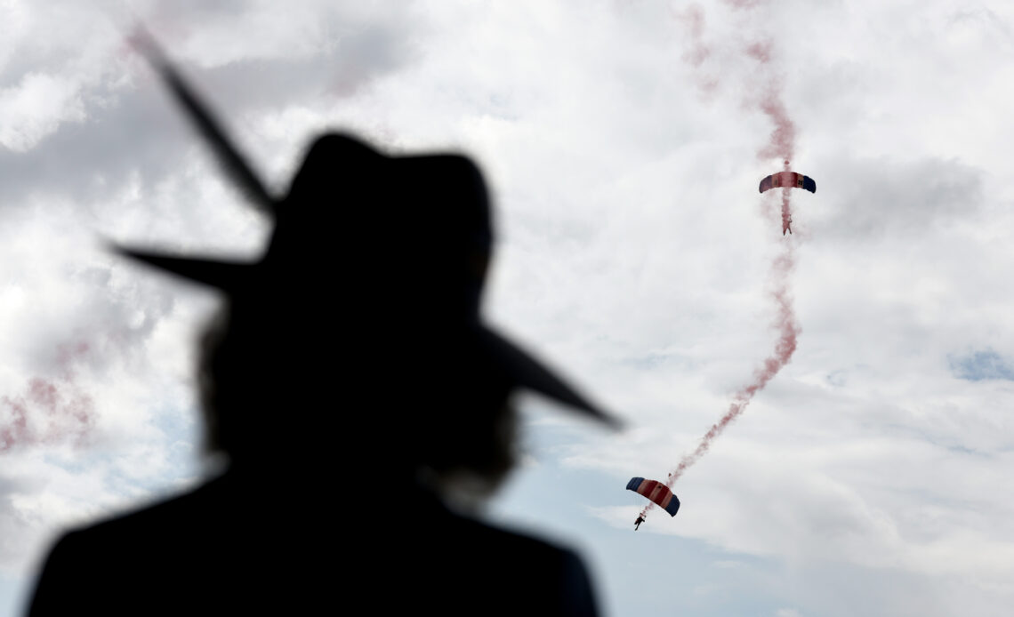 Queen Camilla looks up at parachutists
