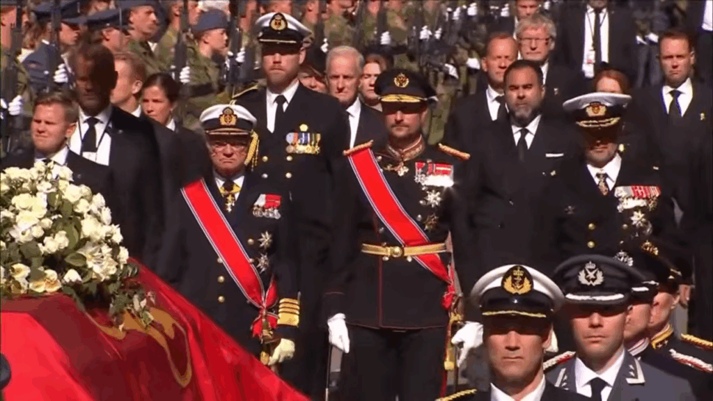 King Haakon, flanked by King Carl XVI Gustaf and King Frederik, walk behind King Harald's coffin